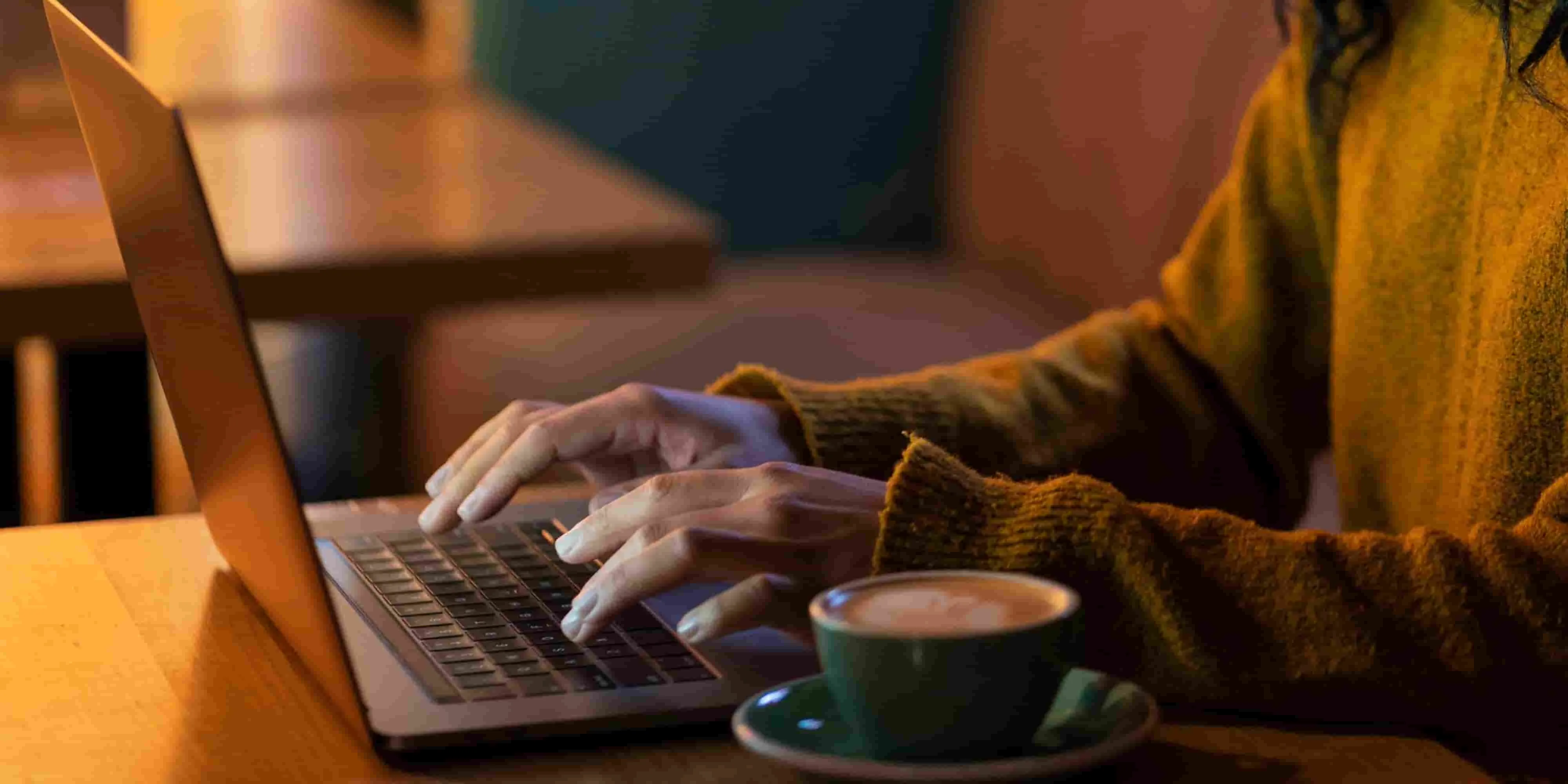 Business professional reviewing personalised email outreach on a laptop in a modern office