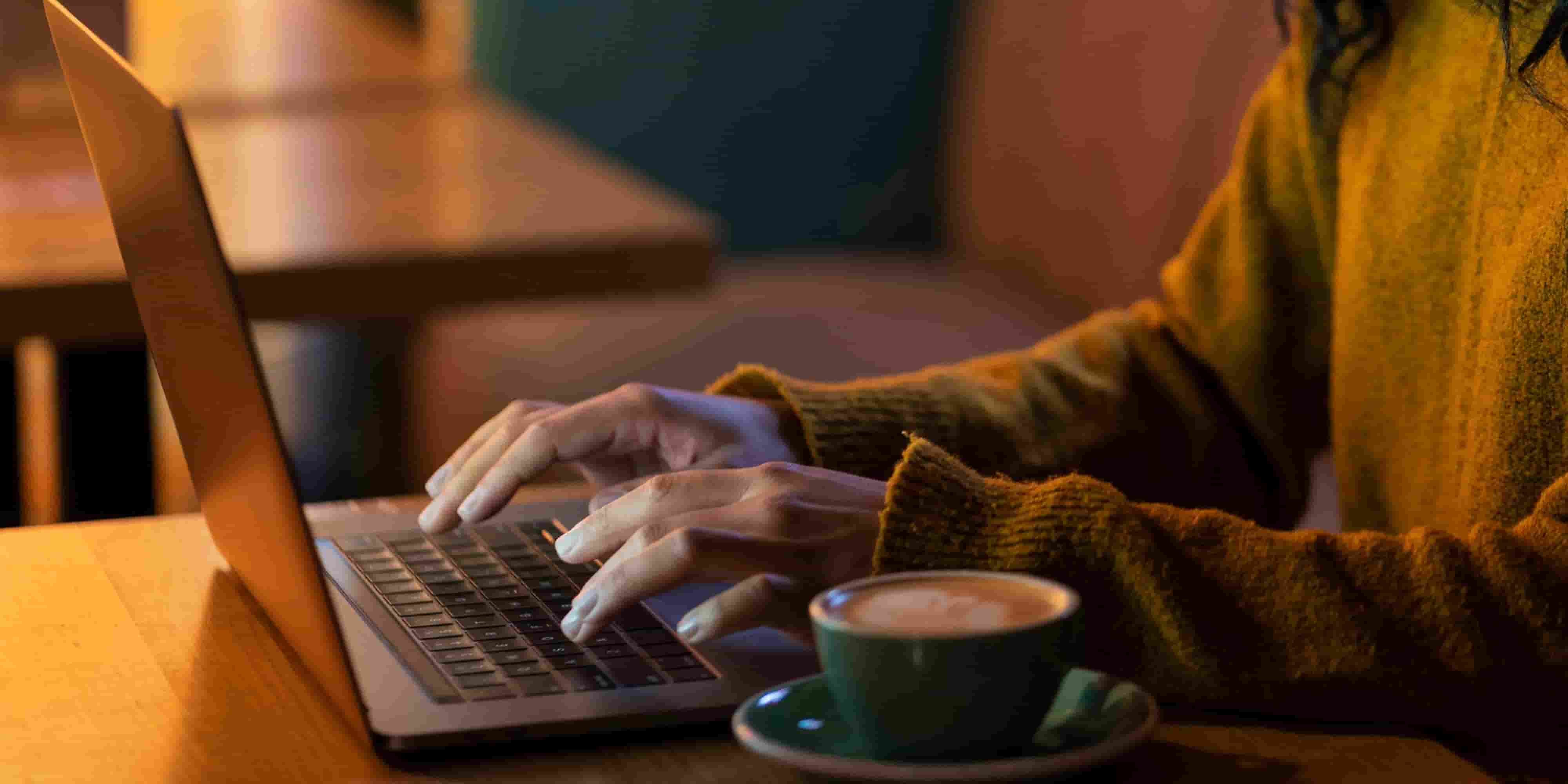 Business professional reviewing personalised email outreach on a laptop in a modern office